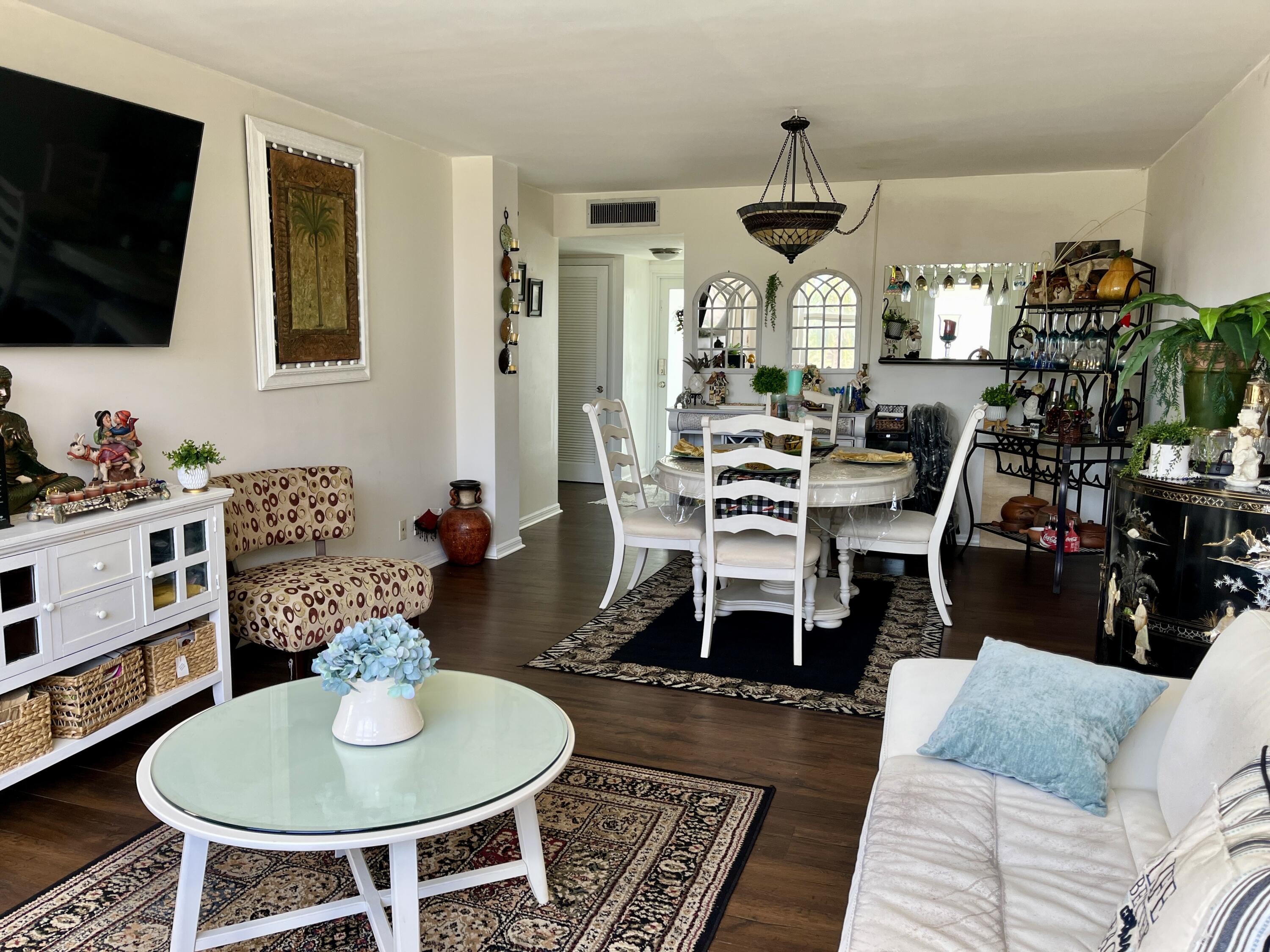 201 North Ocean Boulevard, Unit 302 Pompano Beach, FL 33062 - Photo 6 of 39 a living room with furniture and a flat screen tv