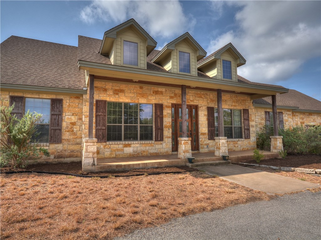 306 Frontera Ranch Cove Dripping Springs, TX 78620 - Photo 1 of 1 a front view of a house with a yard and garage