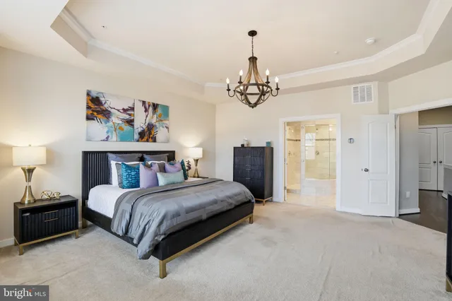 a bedroom with a bed and a chandelier