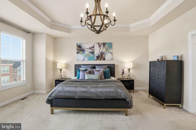 a bedroom with a bed dresser and window