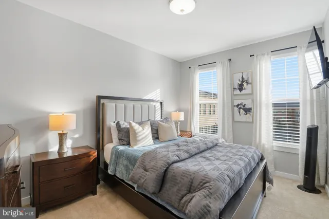 a bedroom with a bed and lamp