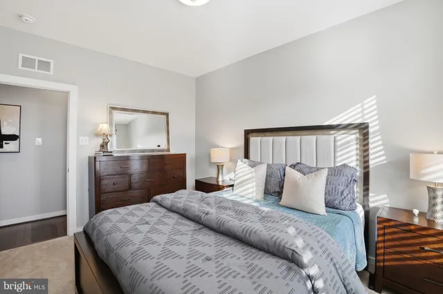 a bedroom with a bed and a dresser