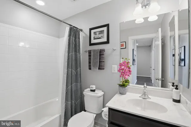 a bathroom with a sink vanity tub and toilet