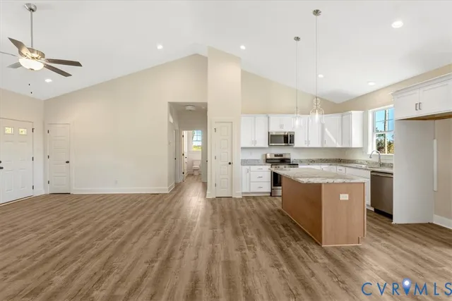 a kitchen with a refrigerator a sink and dishwasher a oven with wooden floor