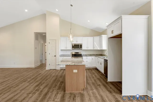 a kitchen with a refrigerator a stove top oven a sink and cabinets
