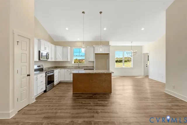 a kitchen with granite countertop a sink and a window