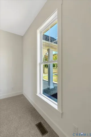 an empty room with a ceiling fan and closet area