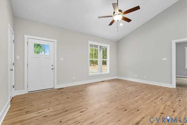 wooden floor in an empty room with a window