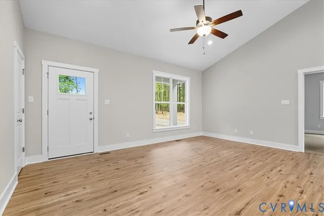 wooden floor in an empty room with a window