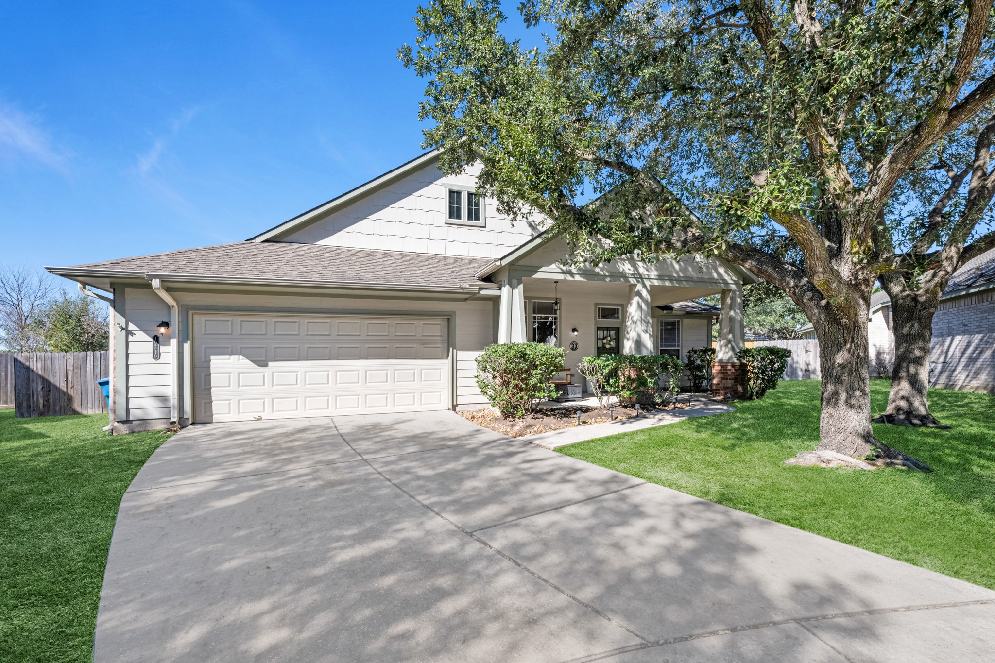 a front view of a house with yard and green space