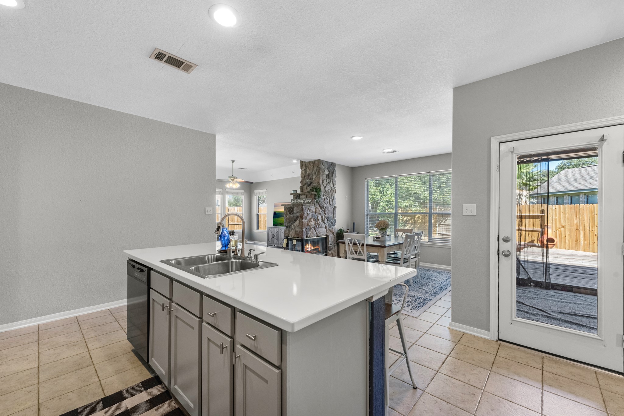 19310 Arbor Breeze Court Spring, TX 77379 - Photo 12 of 37 a kitchen with kitchen island a sink dining table and chairs