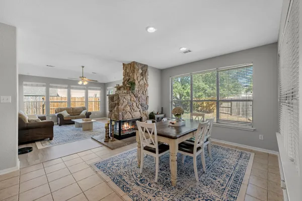 a dining room with furniture and a large window