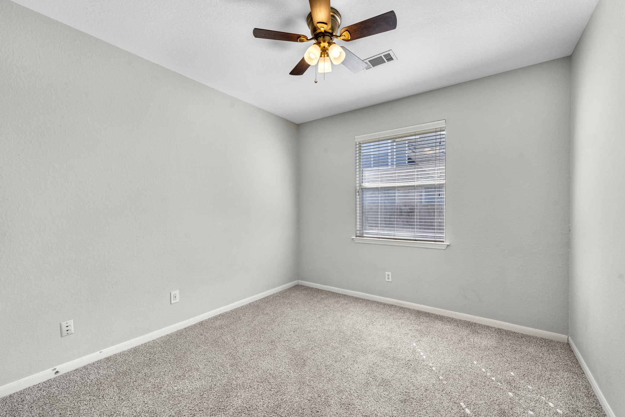 19310 Arbor Breeze Court Spring, TX 77379 - Photo 24 of 37 an empty room with windows and ceiling fan