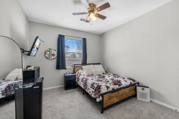 a bedroom with a bed and a chandelier