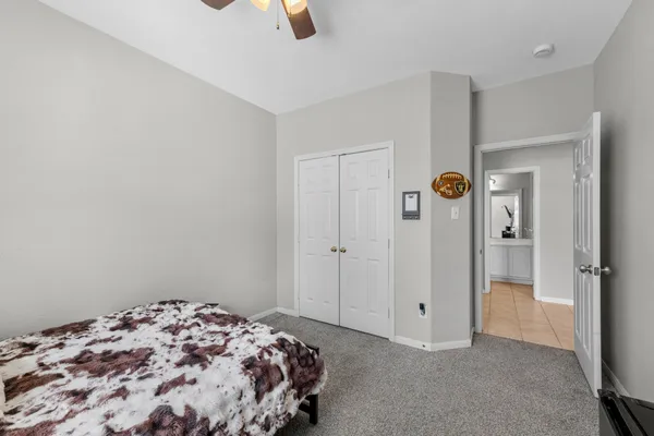 a bedroom with a bed and a chandelier