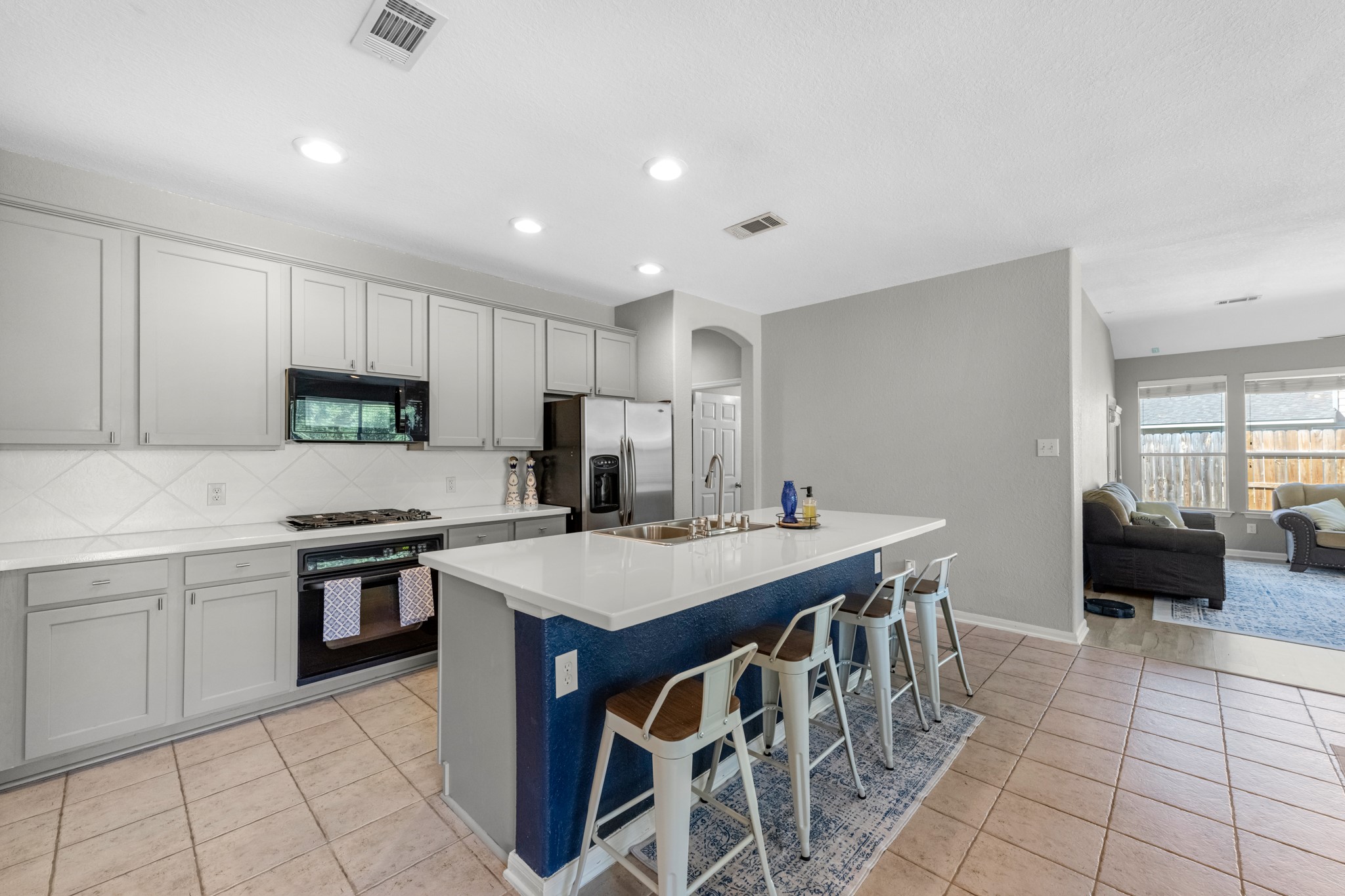 19310 Arbor Breeze Court Spring, TX 77379 - Photo 9 of 37 a kitchen with stainless steel appliances a stove a sink a microwave and a refrigerator