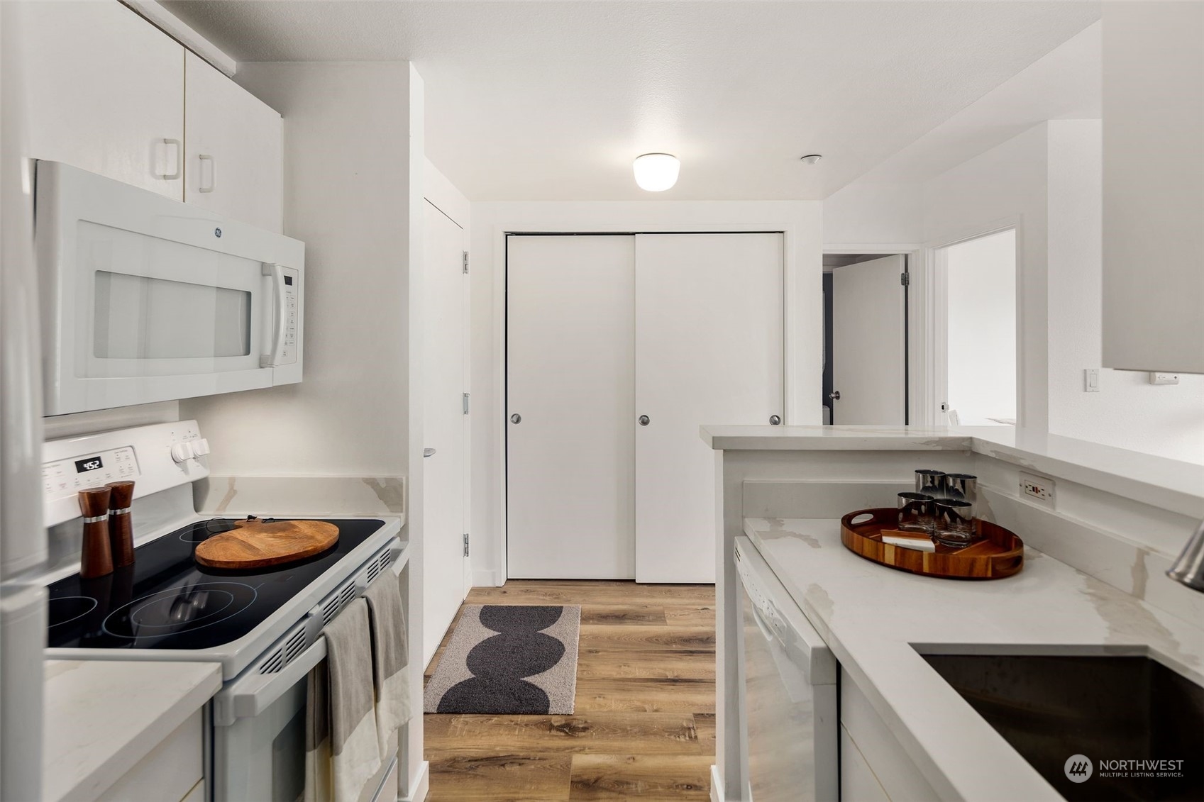 1415 2nd Avenue, Unit 2008 Seattle, WA 98101 - Photo 14 of 36 a kitchen with cabinets and appliances
