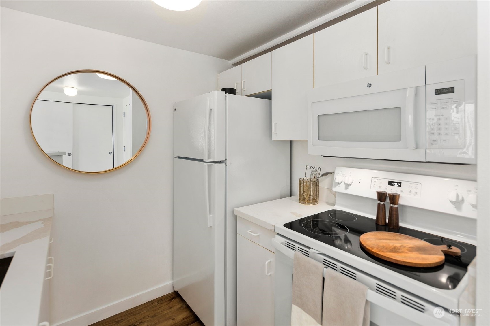1415 2nd Avenue, Unit 2008 Seattle, WA 98101 - Photo 10 of 36 a kitchen with a sink a stove and refrigerator