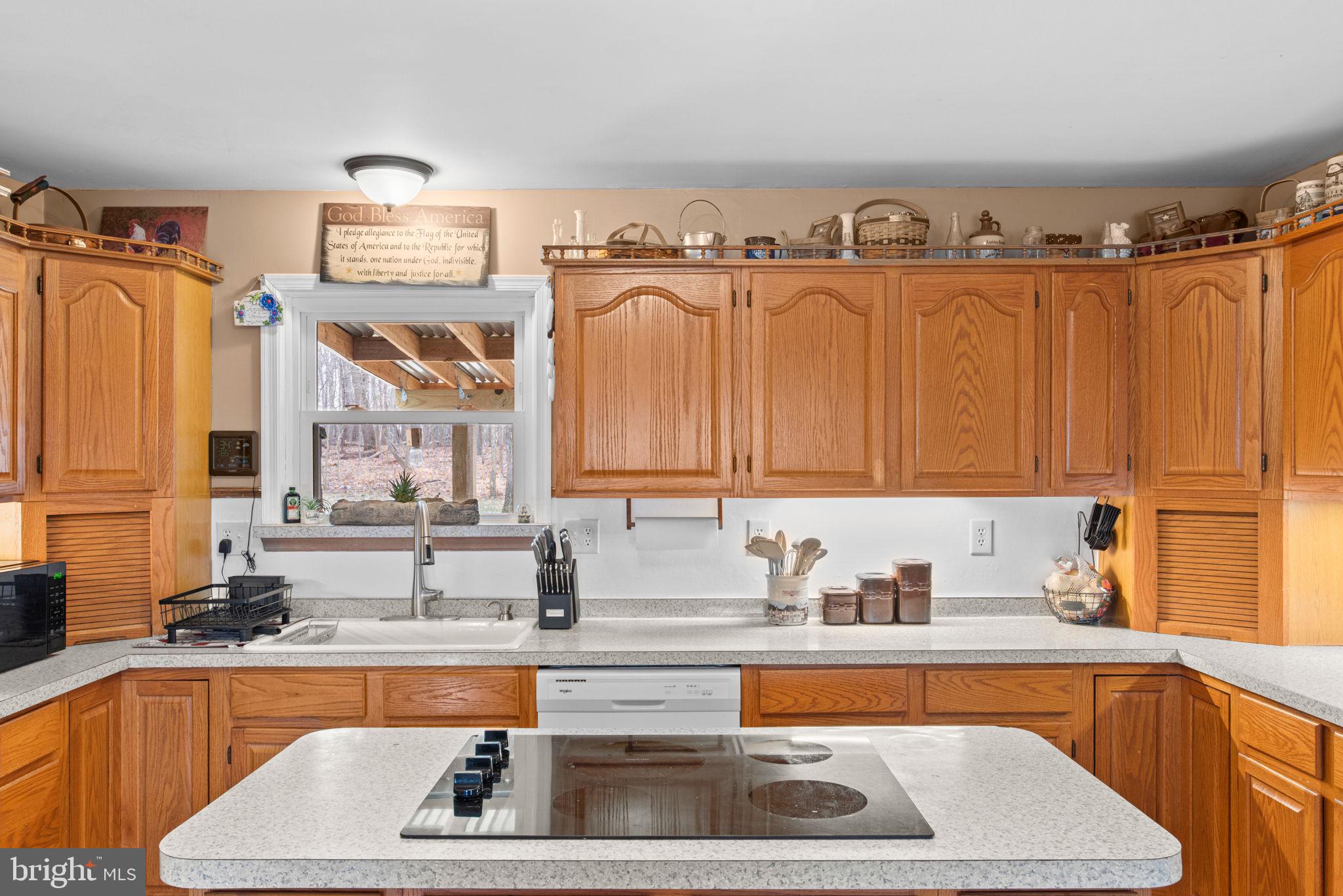 19773 Haugh Road Stewartstown, PA 17363 - Photo 11 of 58 a kitchen with granite countertop a sink and a wooden cabinets