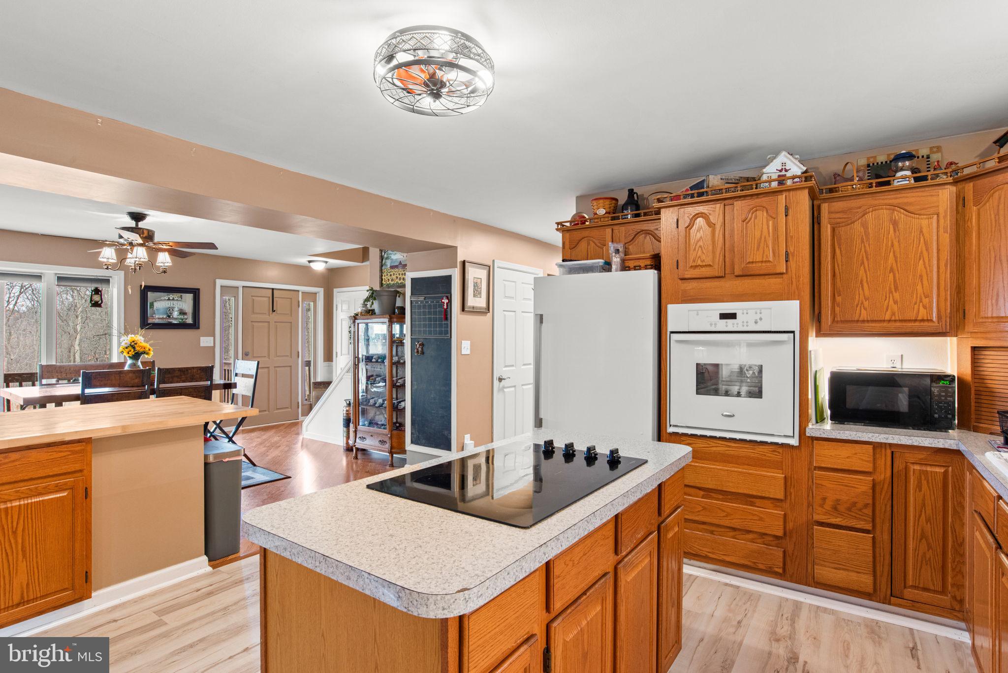 19773 Haugh Road Stewartstown, PA 17363 - Photo 13 of 58 a kitchen with stainless steel appliances granite countertop a sink stove and refrigerator