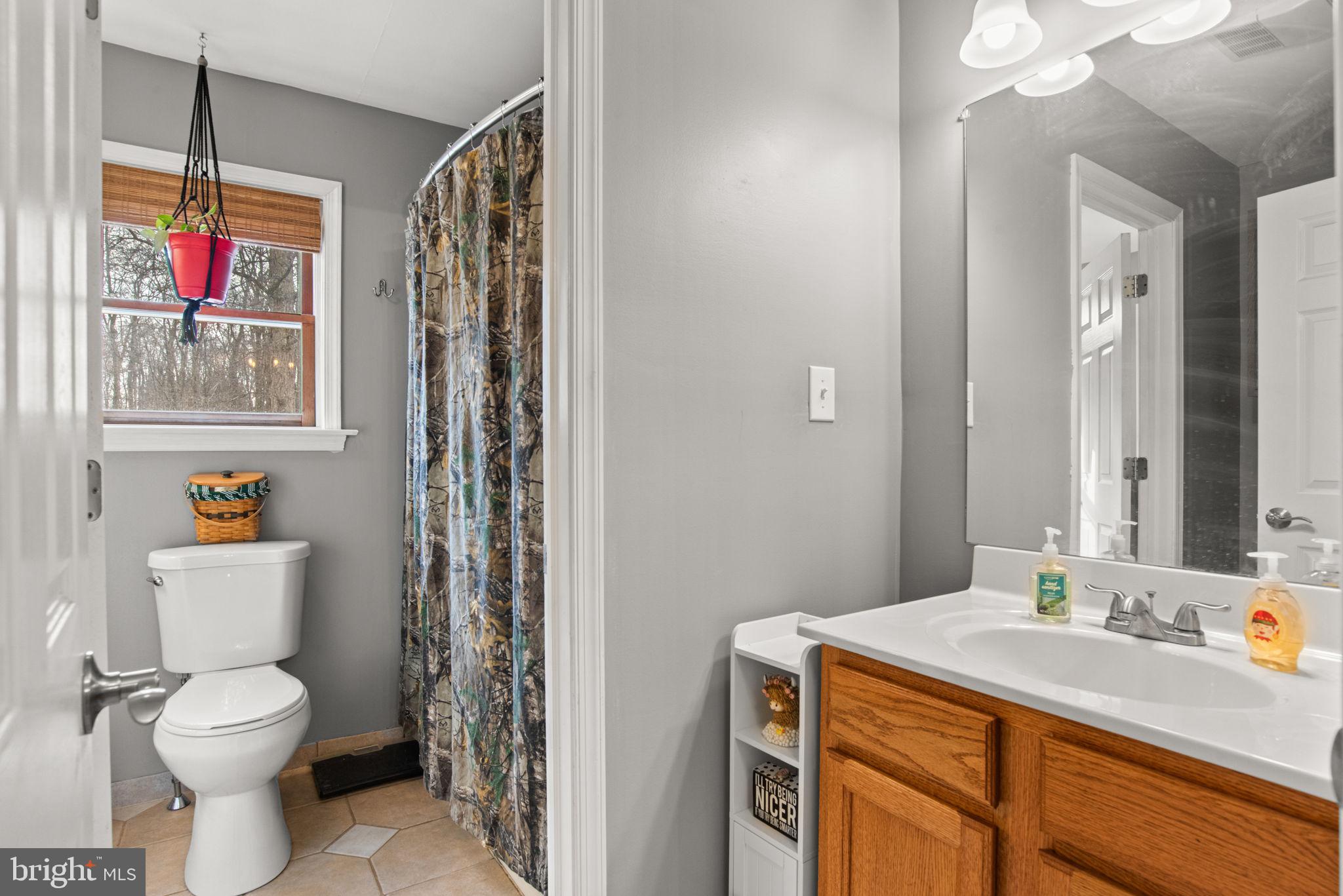 19773 Haugh Road Stewartstown, PA 17363 - Photo 28 of 58 a bathroom with a granite countertop sink mirror vanity and toilet
