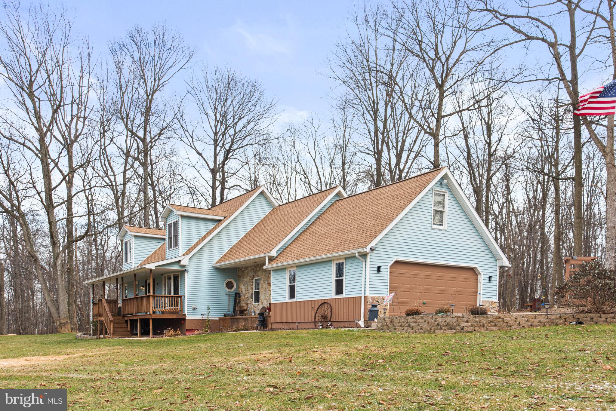 19773 Haugh Road Stewartstown, PA 17363 - Photo 3 of 58 a front view of house with yard and trees in the background