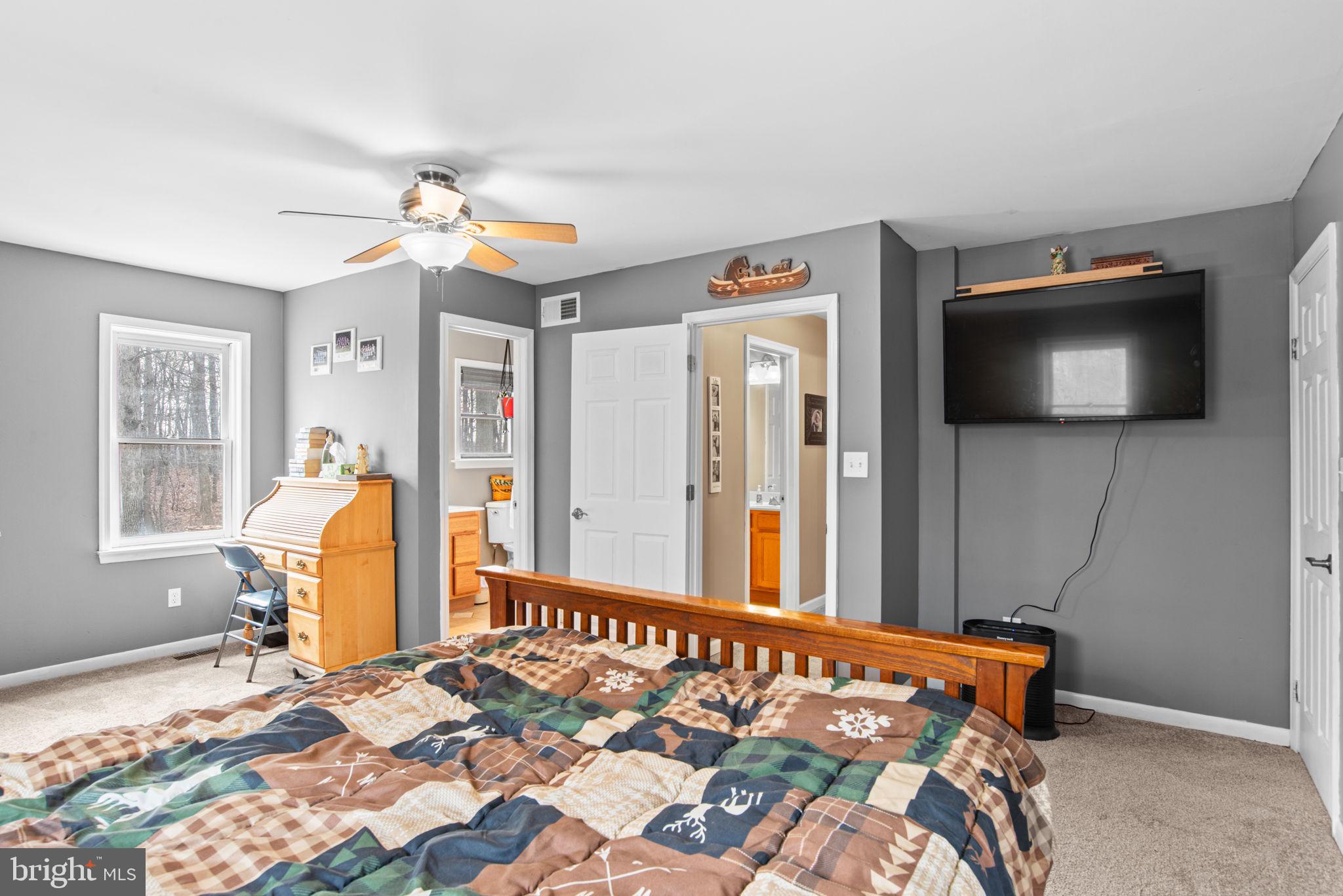 19773 Haugh Road Stewartstown, PA 17363 - Photo 32 of 58 a bedroom with a bed and a flat screen tv