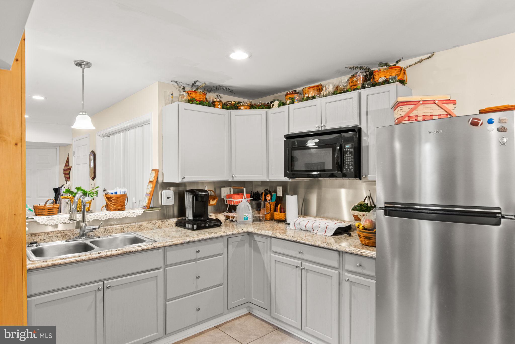 19773 Haugh Road Stewartstown, PA 17363 - Photo 47 of 58 a kitchen with refrigerator a sink a stove and cabinets