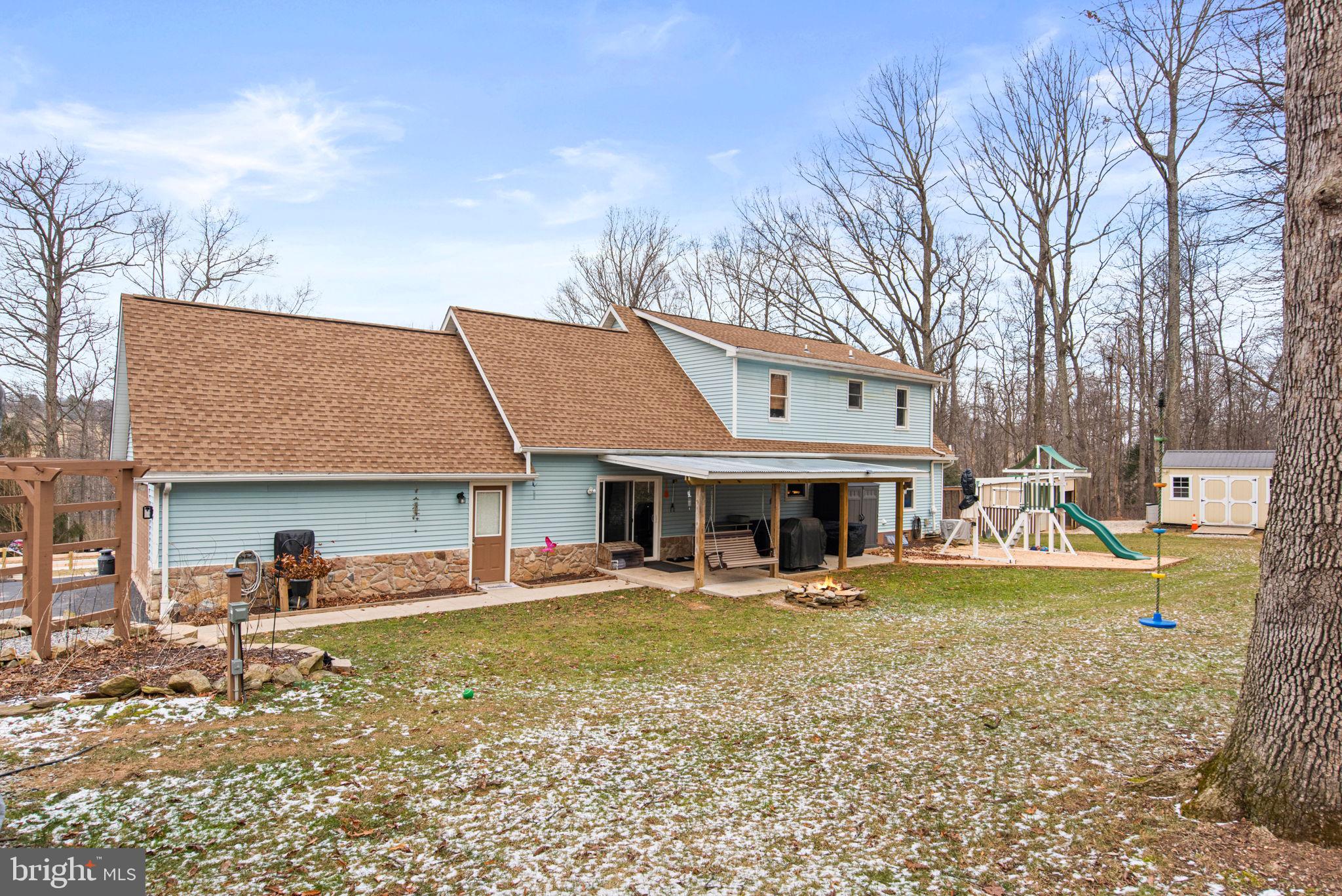 19773 Haugh Road Stewartstown, PA 17363 - Photo 54 of 58 a view of a house with a yard patio and fire pit