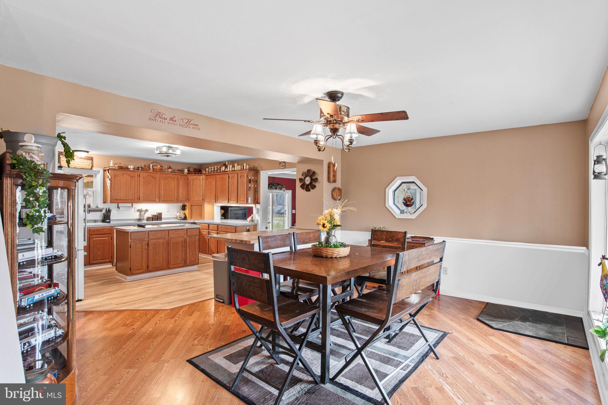 19773 Haugh Road Stewartstown, PA 17363 - Photo 8 of 58 a view of a dining room and livingroom with furniture wooden floor and a rug