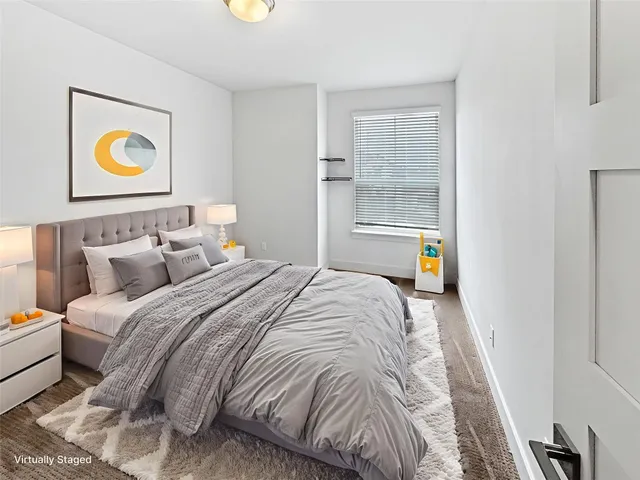 a bedroom with a bed and painting on the wall