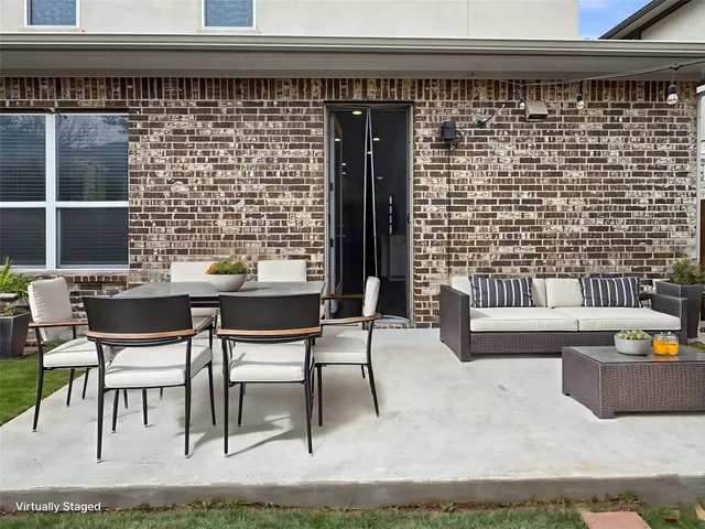 a balcony with table and chairs