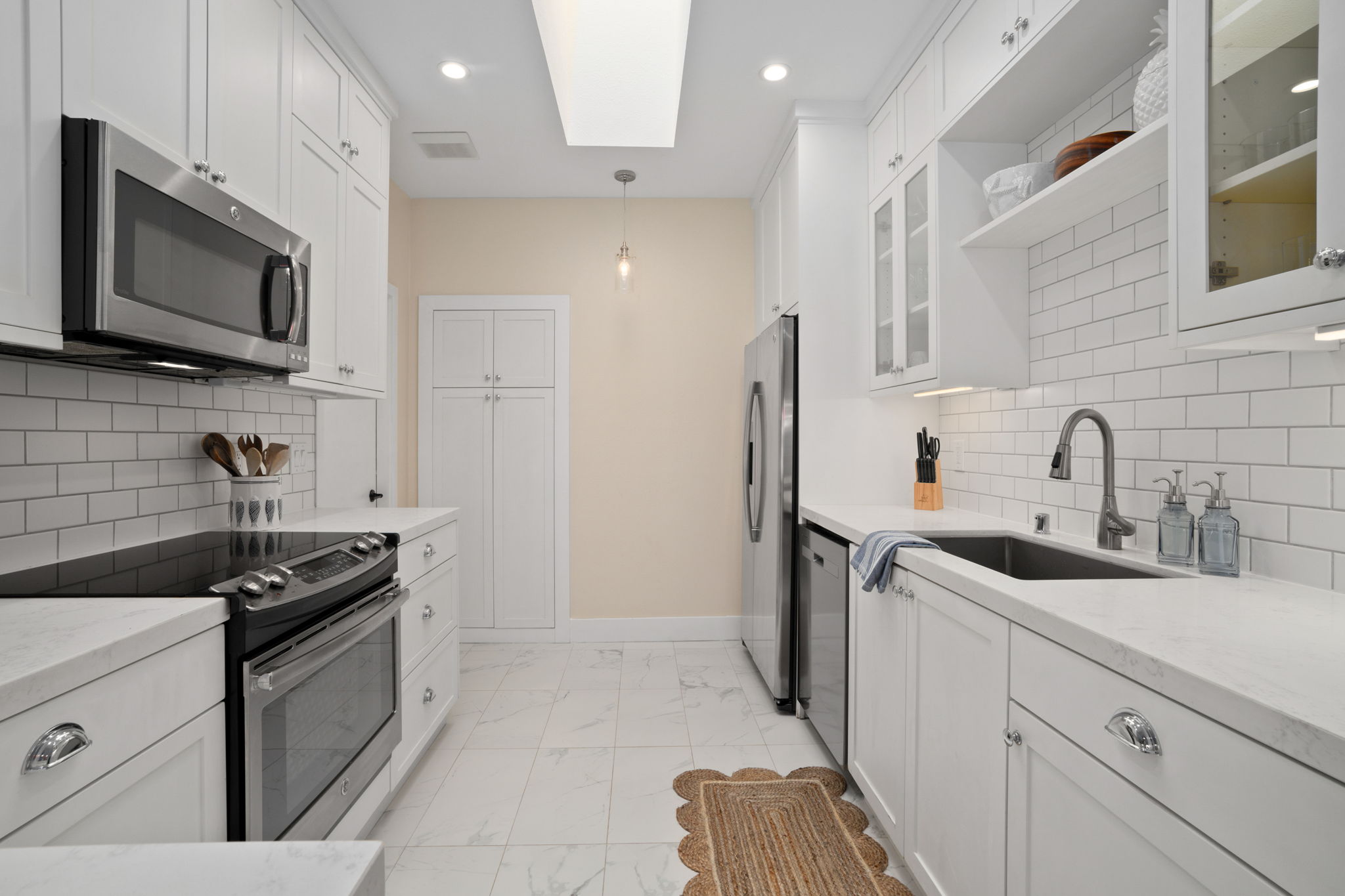 1753 Kelaukia Street Koloa, HI 96756 - Photo 12 of 27 a kitchen with a sink stove and microwave