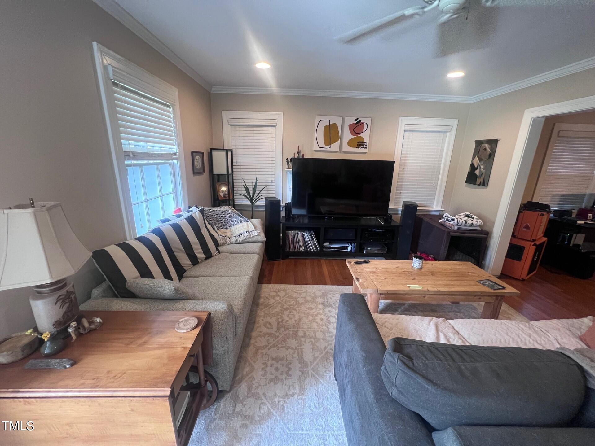 2260 The Circle Raleigh, NC 27608 - Photo 2 of 9 a living room with furniture and a flat screen tv