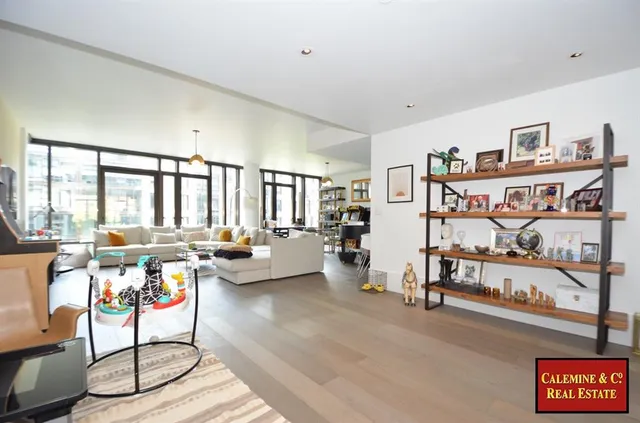 a living room with furniture and large windows