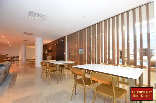 a view of a living room and a kitchen with furniture