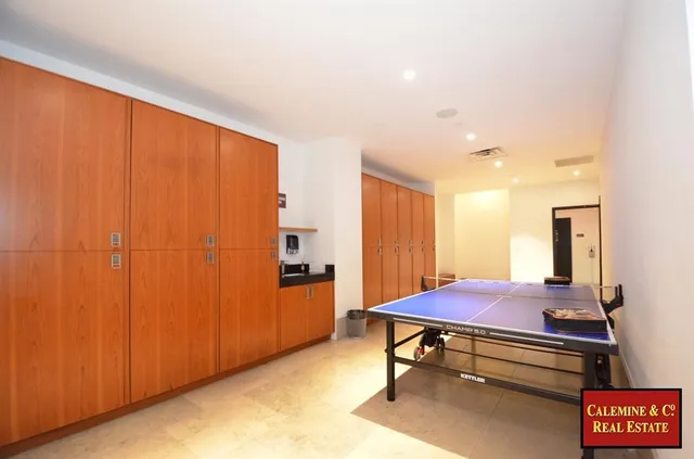 a view of a room with lots of wooden shelves