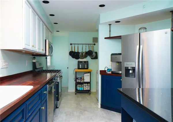 a kitchen with refrigerator and cabinets