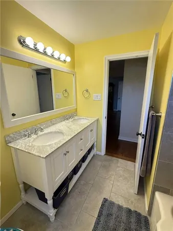 a spacious bathroom with a sink and a mirror
