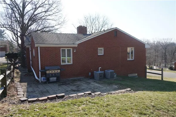 a backyard of a house with barbeque oven