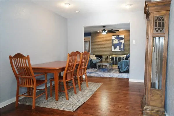 a dining room with furniture wooden floor a glass table and chairs
