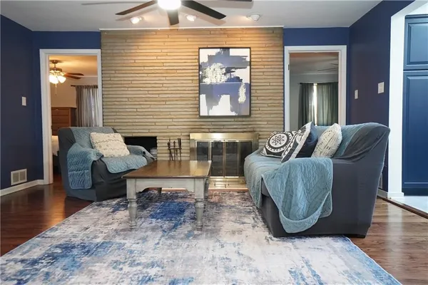 a living room with furniture and wooden floor