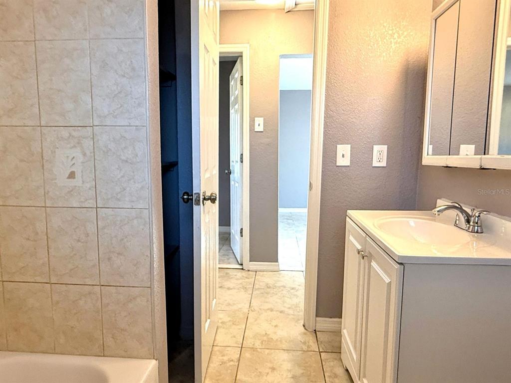 2489 Del Rio Way Dunedin, FL 34698 - Photo 14 of 24 a bathroom with a sink and a mirror