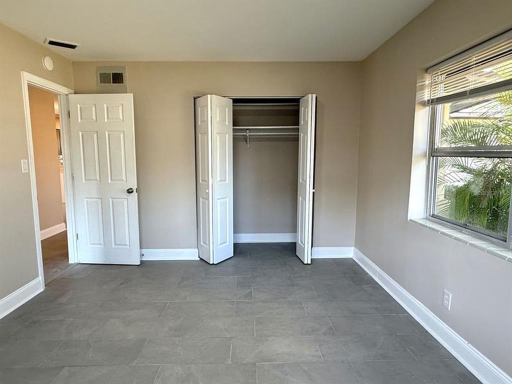 2489 Del Rio Way Dunedin, FL 34698 - Photo 16 of 24 an empty room with windows and closet