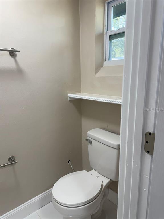 2489 Del Rio Way Dunedin, FL 34698 - Photo 19 of 24 a white toilet sitting next to a window