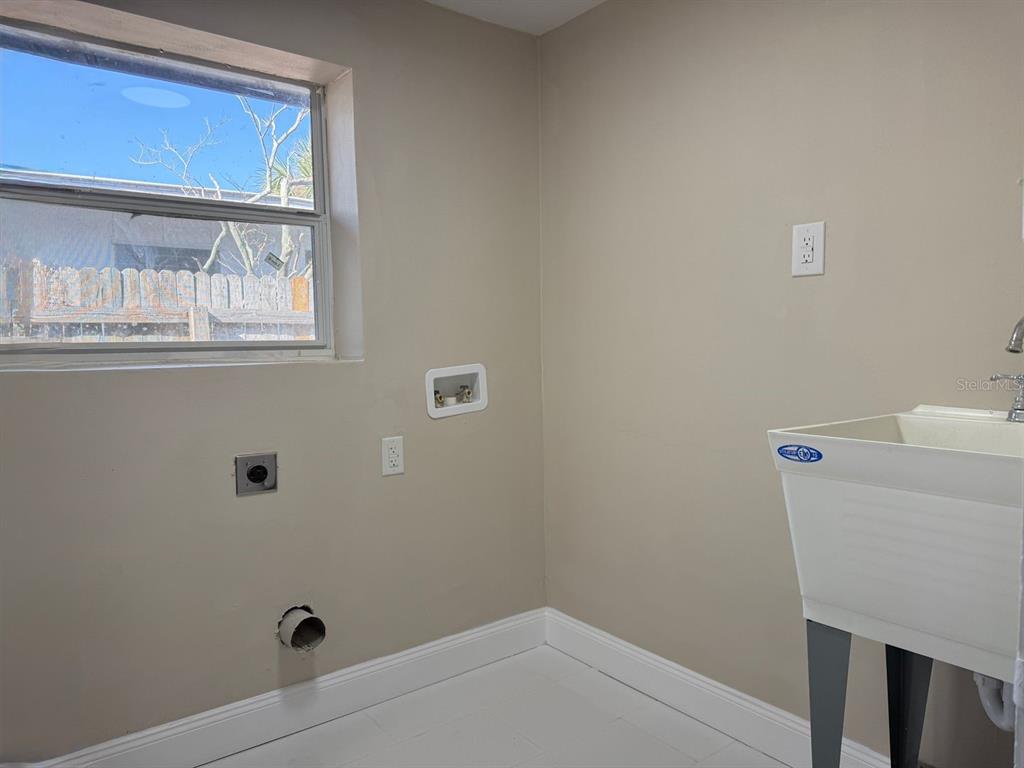 2489 Del Rio Way Dunedin, FL 34698 - Photo 21 of 24 a bathroom with a sink a toilet and a window