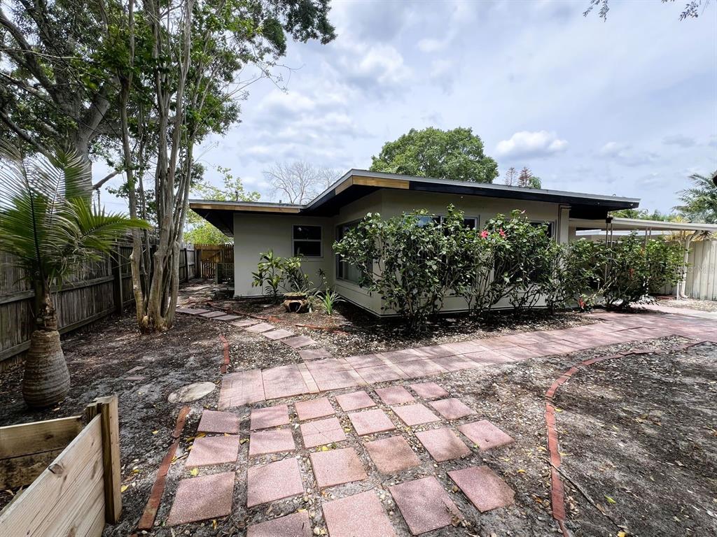 2489 Del Rio Way Dunedin, FL 34698 - Photo 23 of 24 a view of a couches under an umbrella