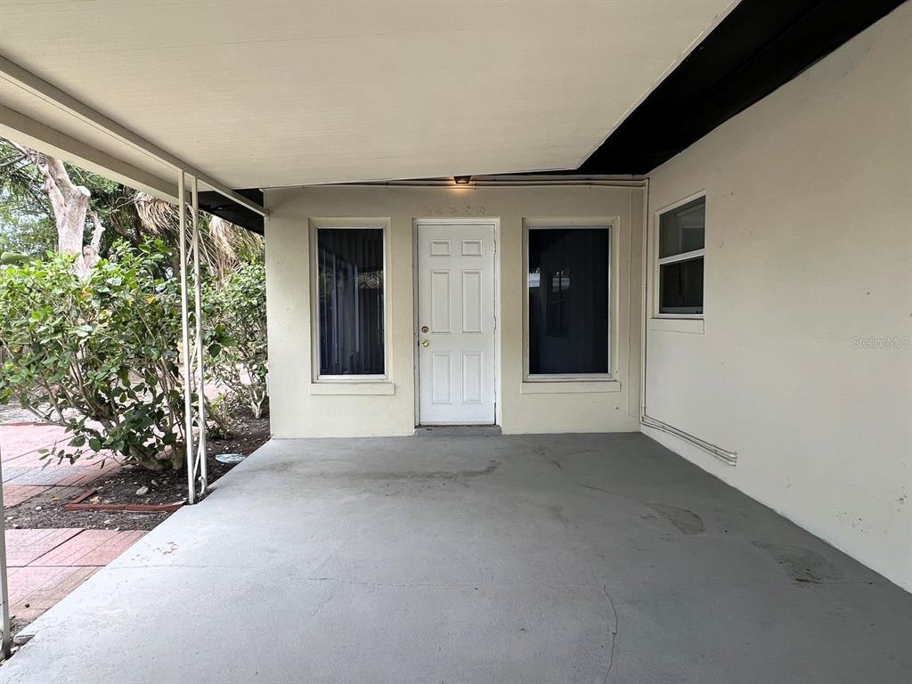 2489 Del Rio Way Dunedin, FL 34698 - Photo 3 of 24 a view of a room with a window and potted plants