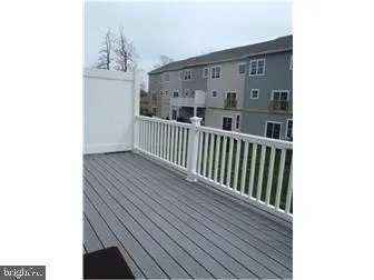 a view of a balcony with wooden floor