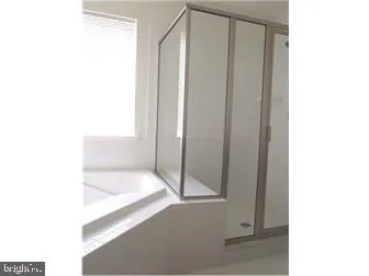 a bathroom with a tub and shower